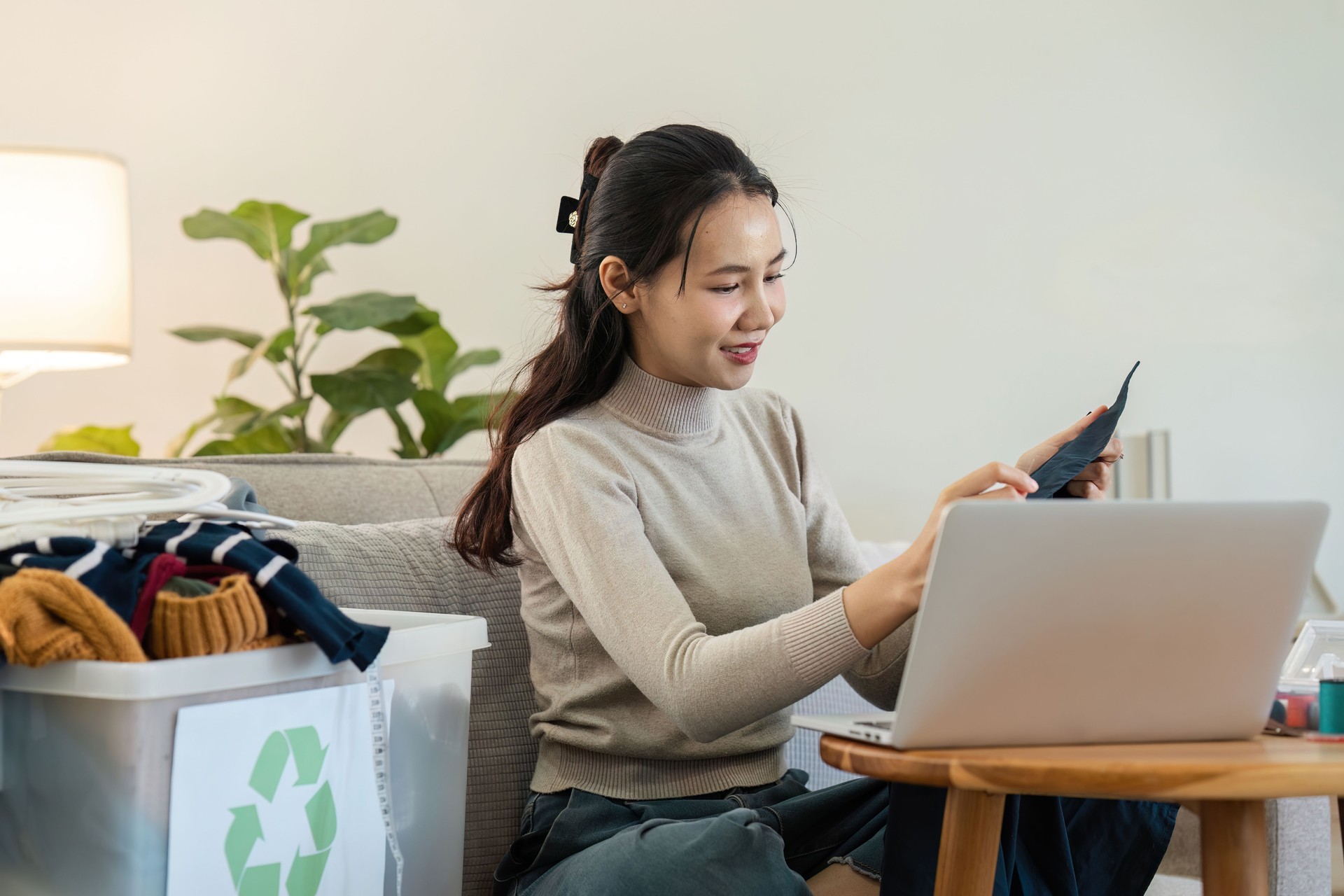 Young Woman Sorting Recyclable Materials at Home, Promoting Eco-Friendly Lifestyle and Sustainable Living Practices, Emphasizing the Importance of Recycling and Environmental Conservation