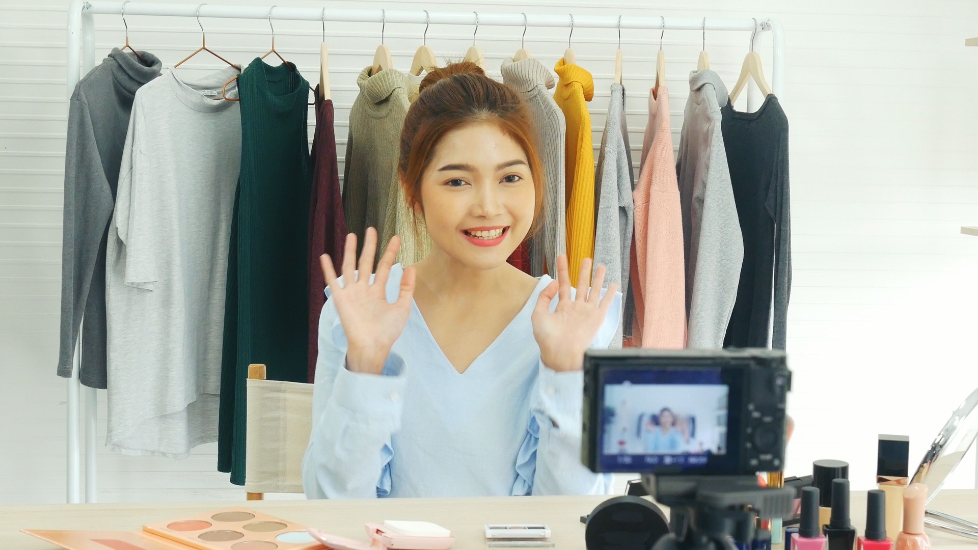 Beauty blogger video production for female fashion blog online cosmetic adviser record woman lifestyle tutorial. Trendy female vlogger showing how to use cosmetics products live via social media.